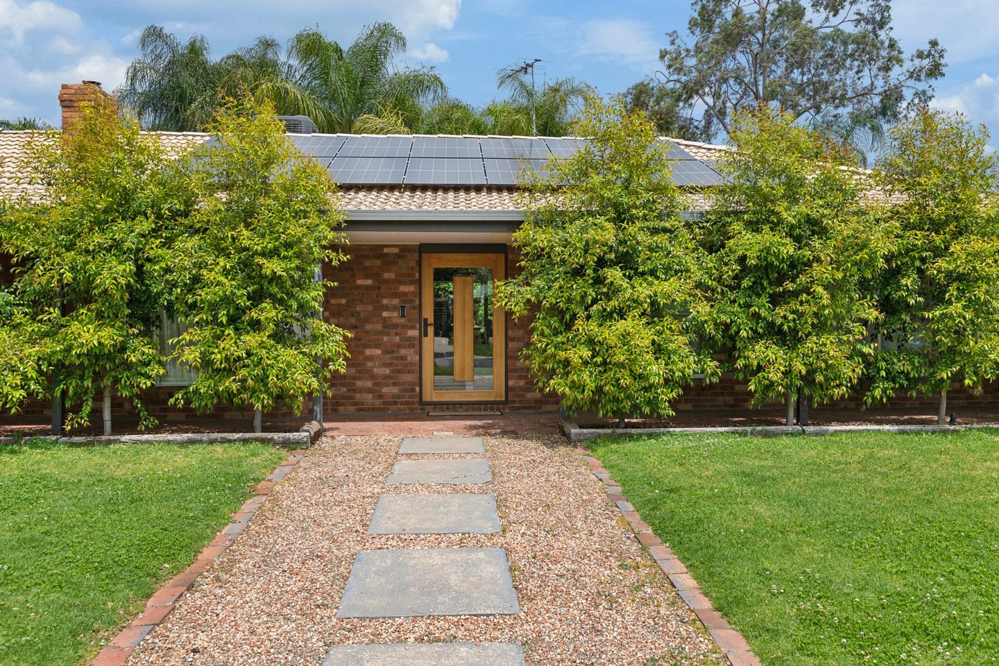 Leafy front garden and brick frontage of 22 Thomson Grove