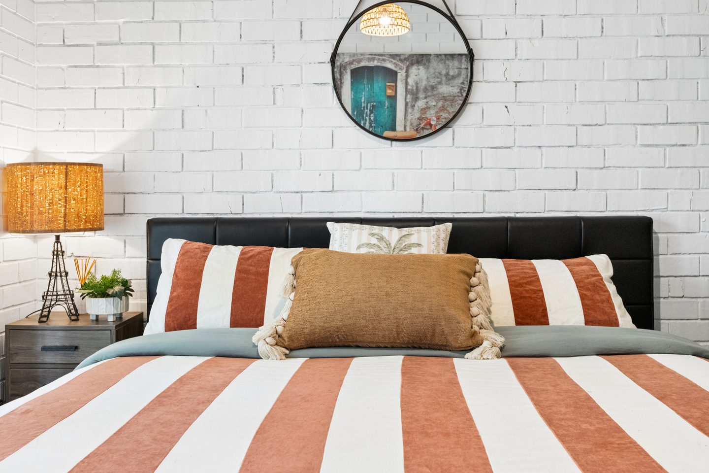 Bedroom detail against white-painted brickwork