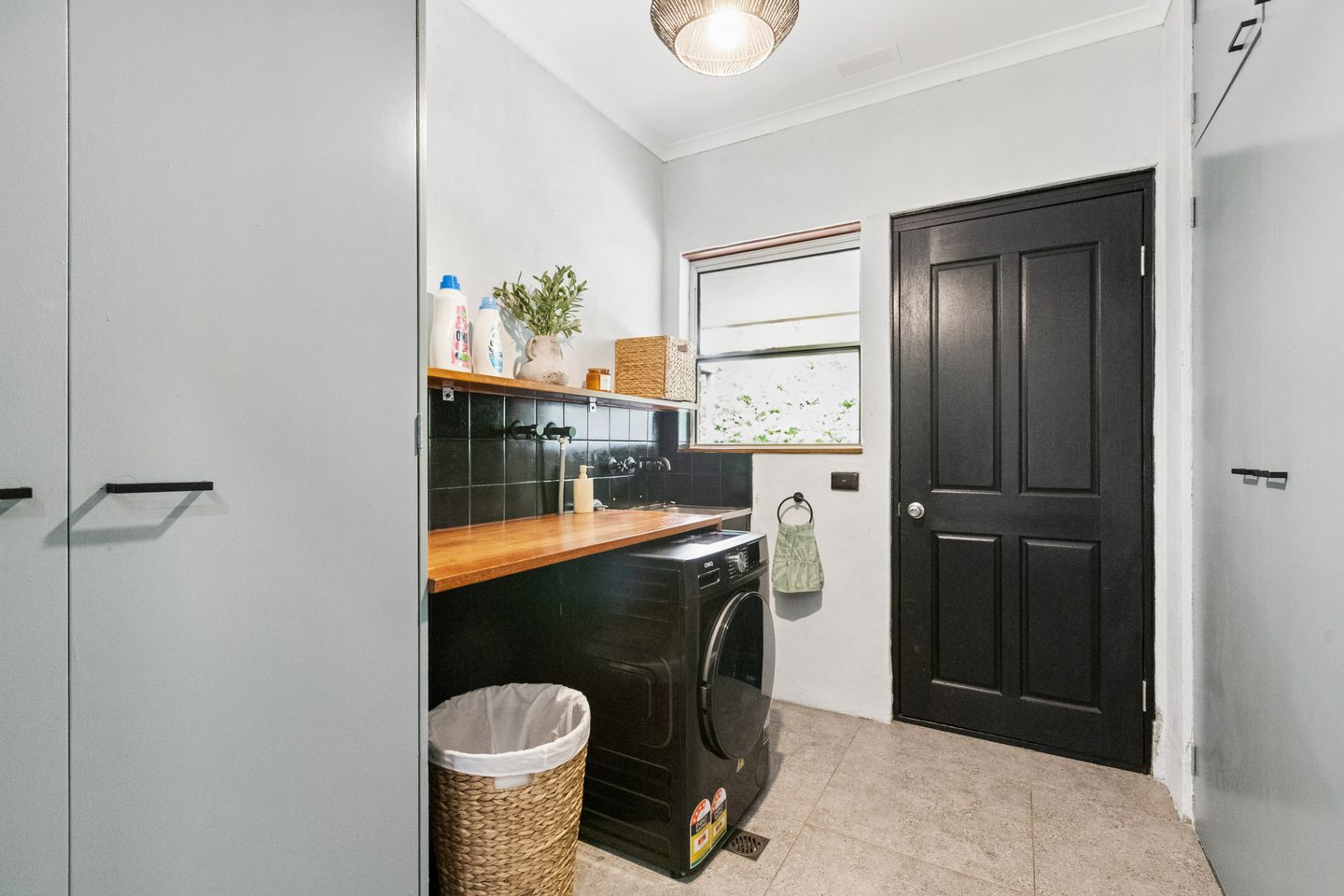 Separate laundry with cabinetry and an external door