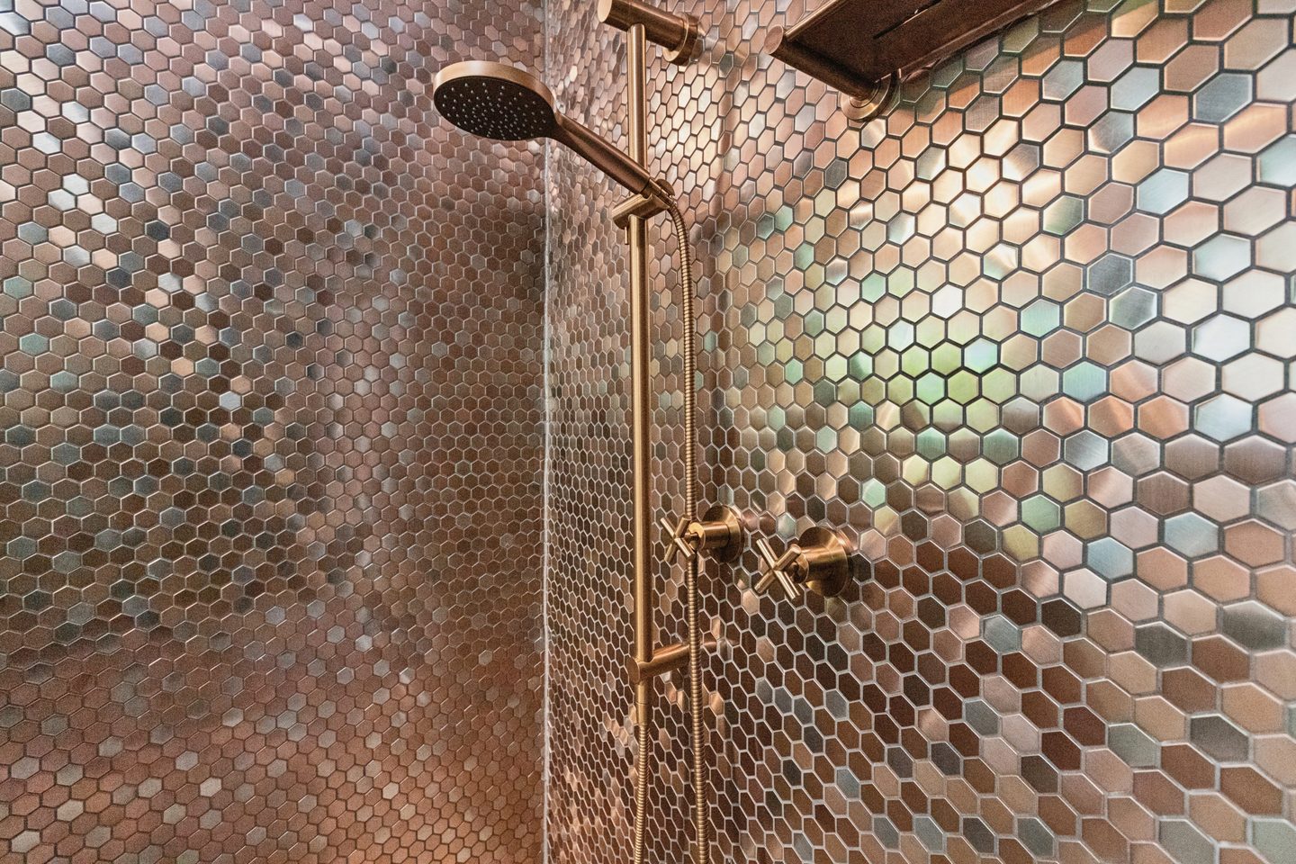 Copper-toned hexagonal shower tiles