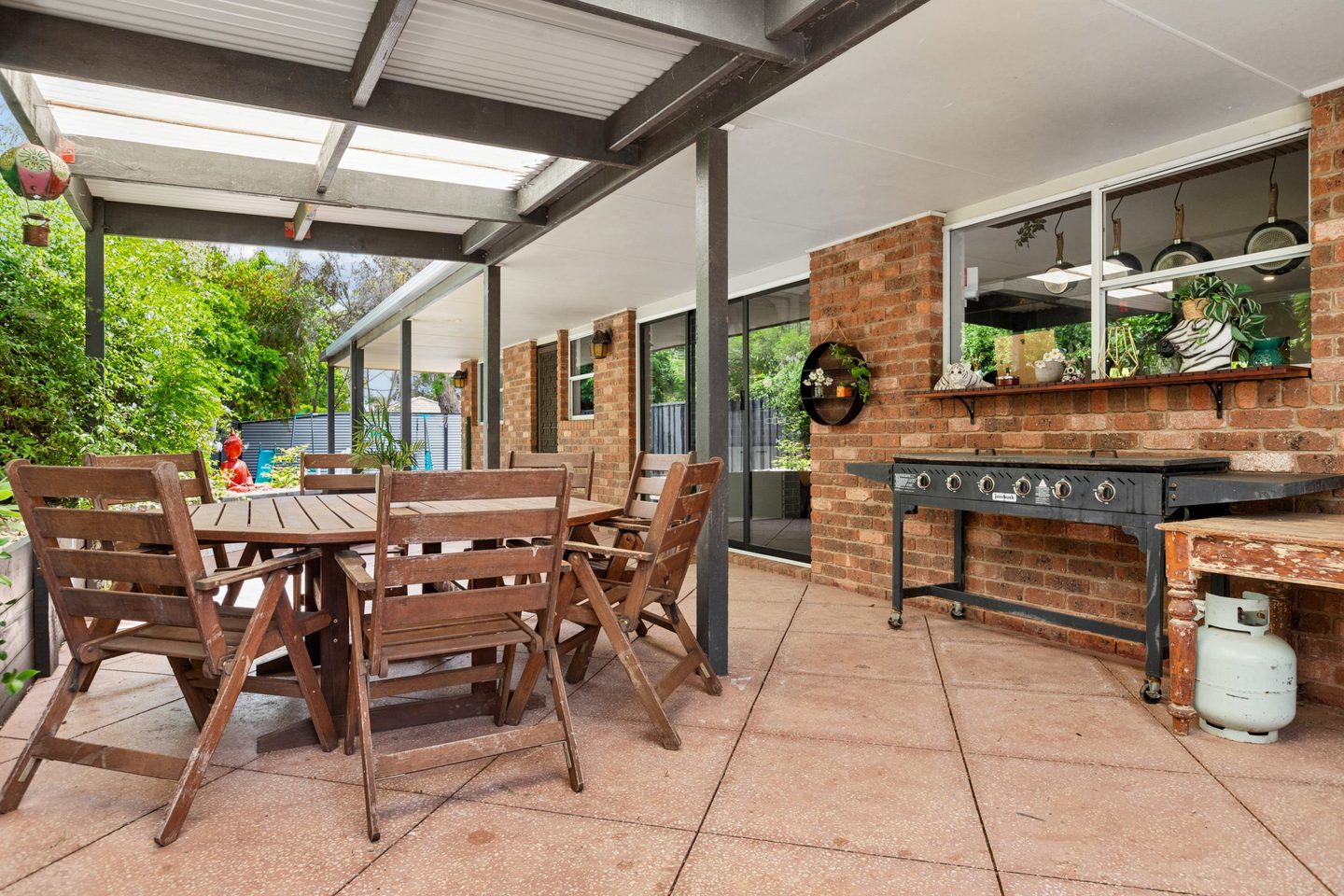 Paved outdoor entertaining area beside the house