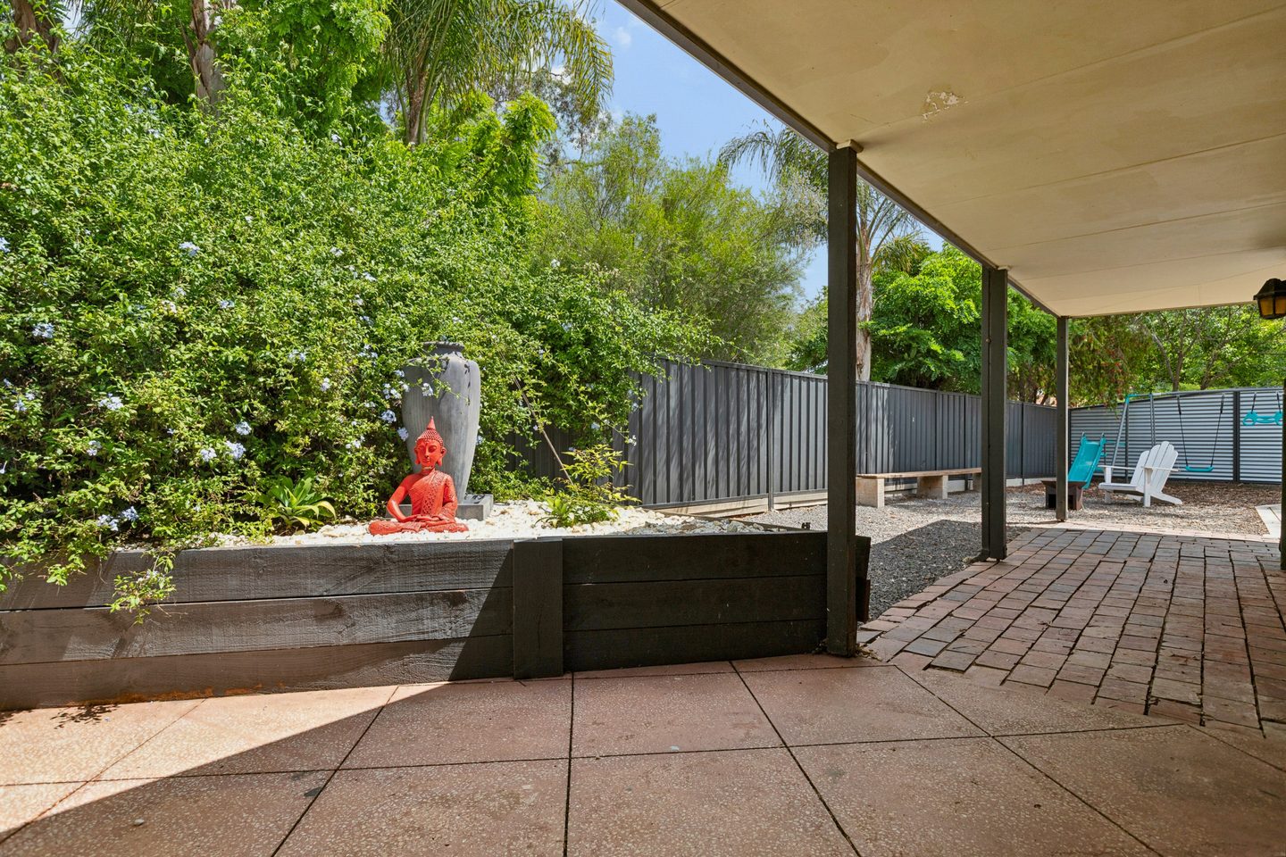 Garden beds and the covered walkway beside the house