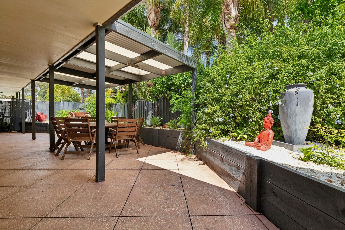 Outdoor entertaining area framed by greenery