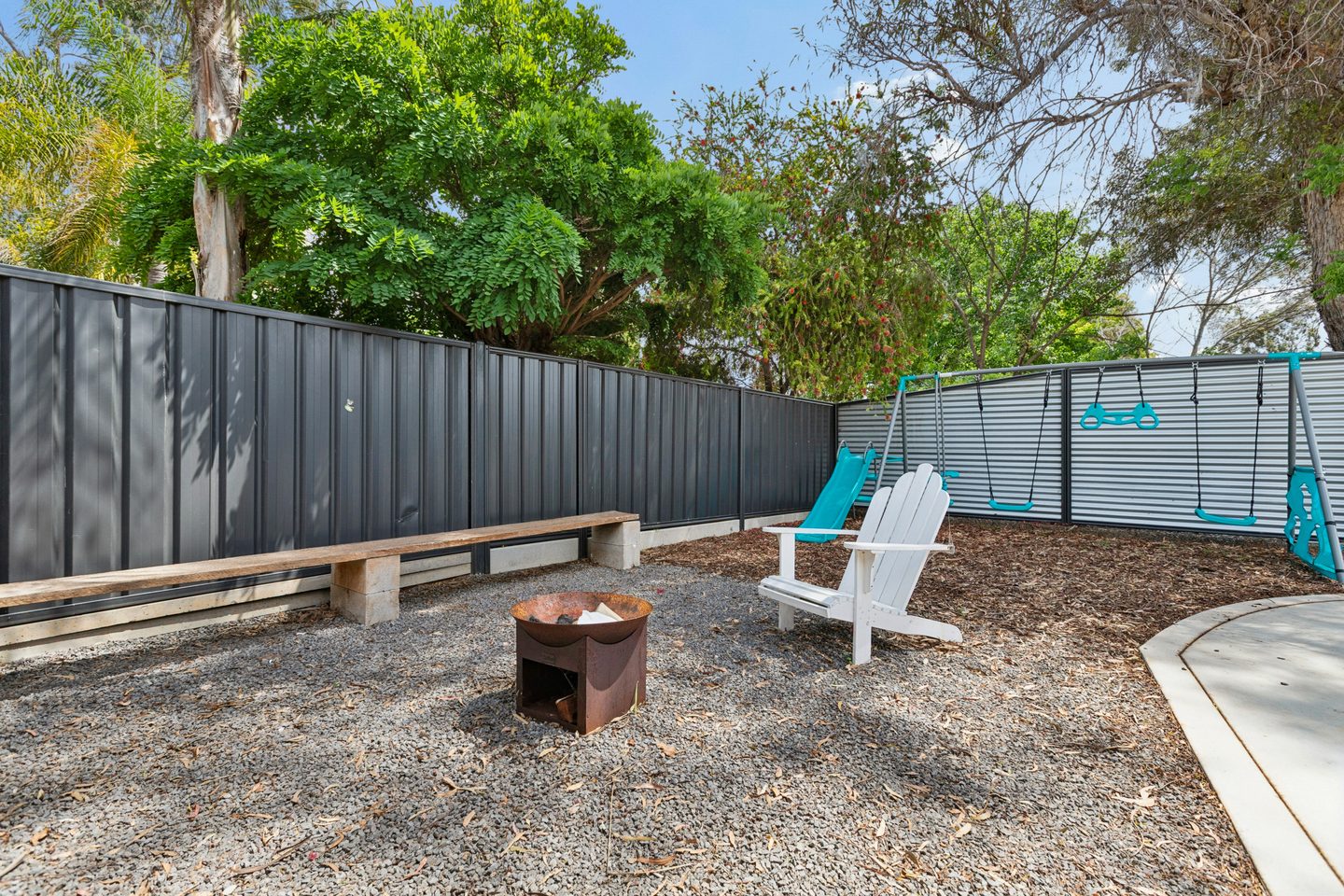 Dedicated firepit area within the fenced yard