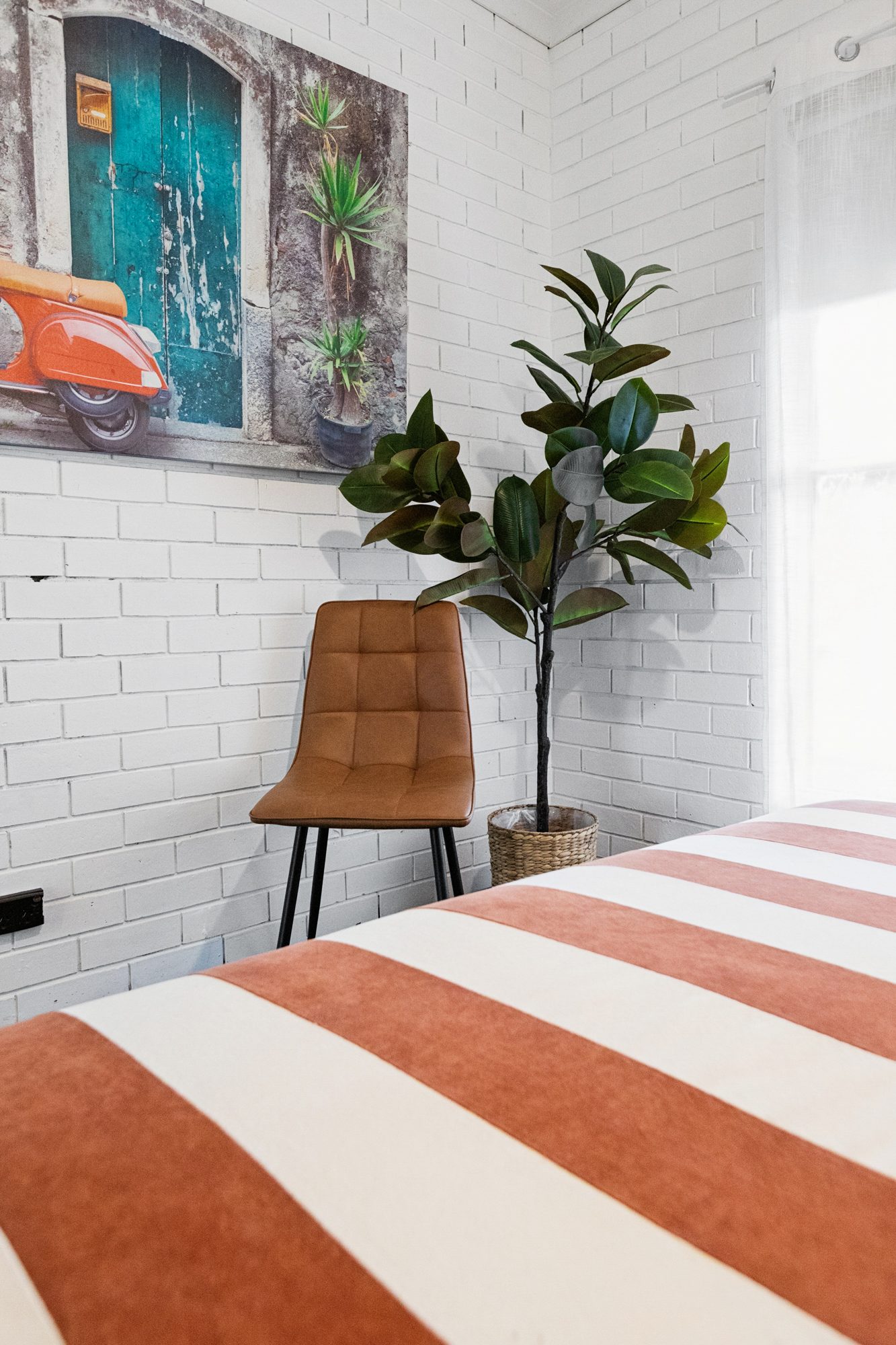 Bedroom corner with white-painted brick walls