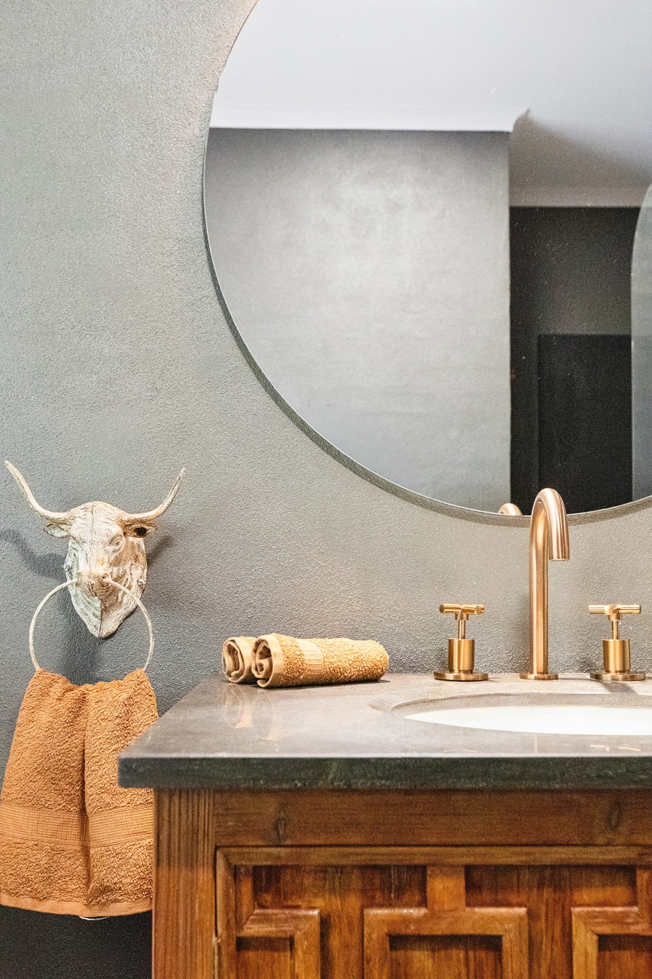 Bathroom vanity and round mirror detail